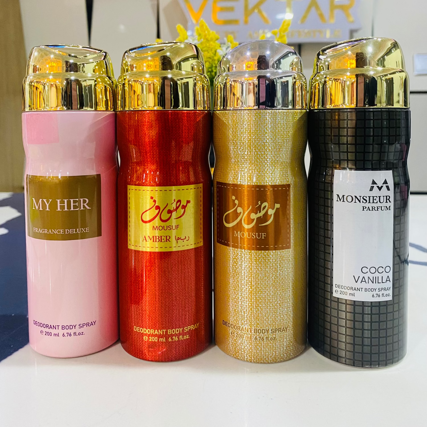 Four deodorant bottles with visible branding in front of a Vektar sign.