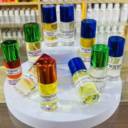 Collection of small perfume bottles with colorful caps on a white stand.
