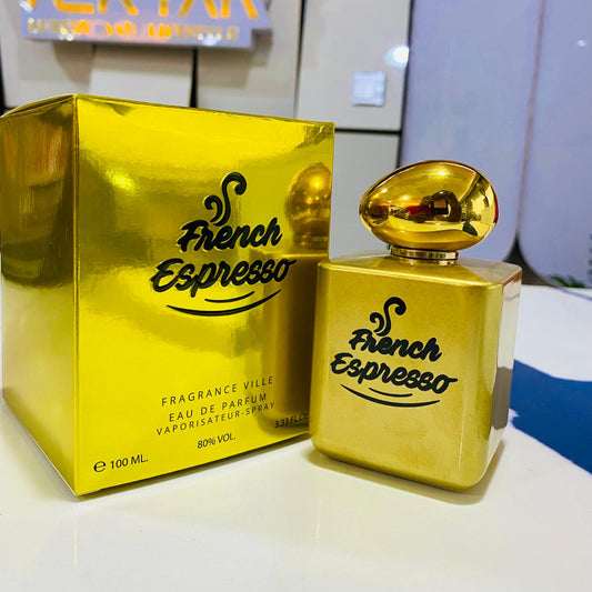 Gold 'French Espresso' perfume bottle and packaging on a white surface with a blurred background.