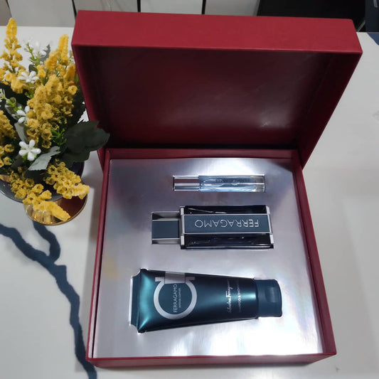 Ferragamo perfume set in a red box with flowers in the background