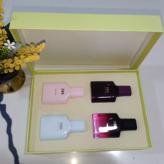Set of four Zara perfume bottles in a box with flowers in the background