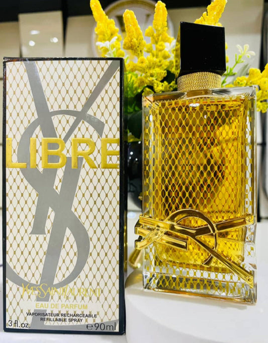 YSL Libre perfume bottle and packaging with yellow flowers in the background