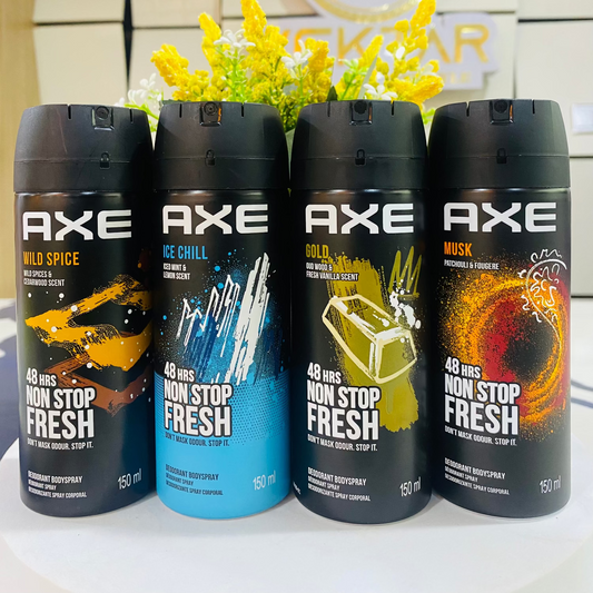 Four Axe deodorant spray bottles on a white surface with a blurred background