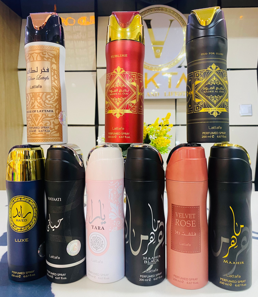 Collection of various perfume bottles on a shelf with a decorative background.