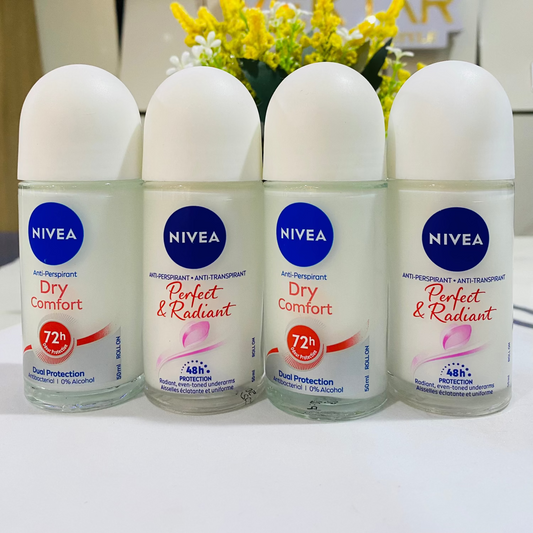 Four Nivea deodorant bottles on a white surface with a blurred background featuring a logo.