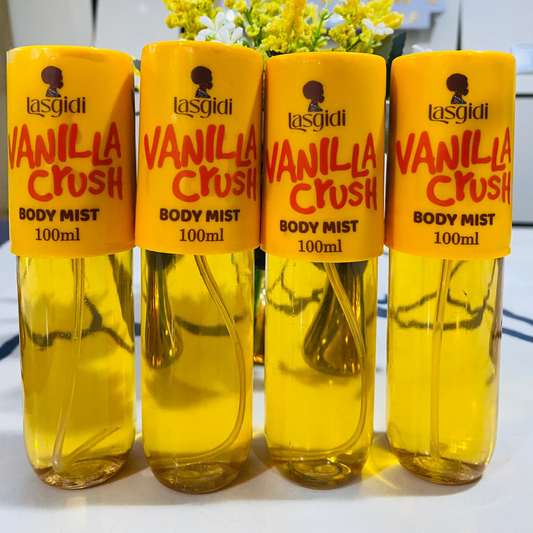 Four bottles of Lasgidi Vanilla Crush body mist on a white surface with a blurred background.