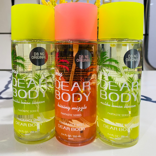 Three bottles of Dear Body products with colorful caps on a white surface.