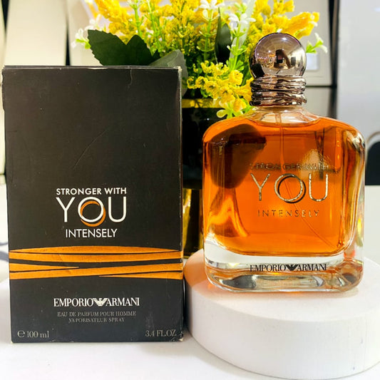 Emporio Armani perfume bottle and packaging with yellow flowers in the background