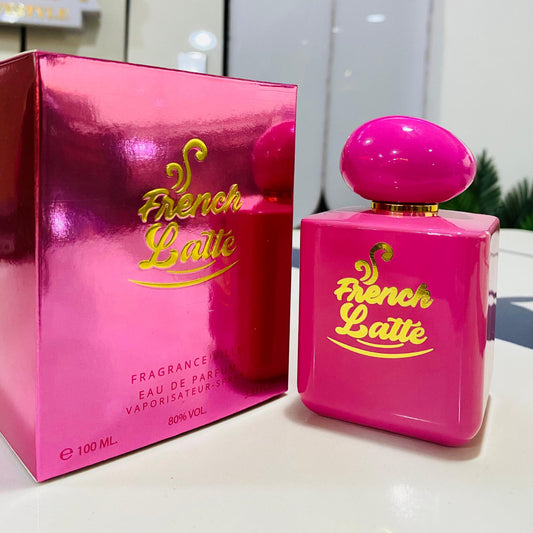 Pink 'French Latte' perfume bottle and packaging on a white surface with a blurred background.