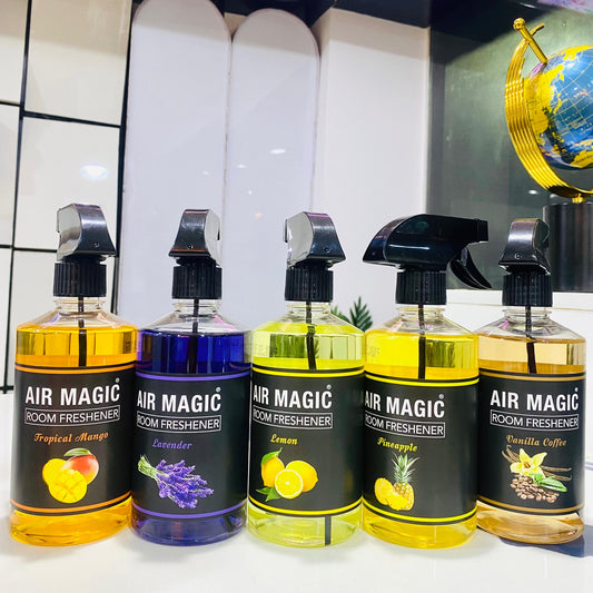 Five bottles of Air Magic room freshener with different scents on a white surface.